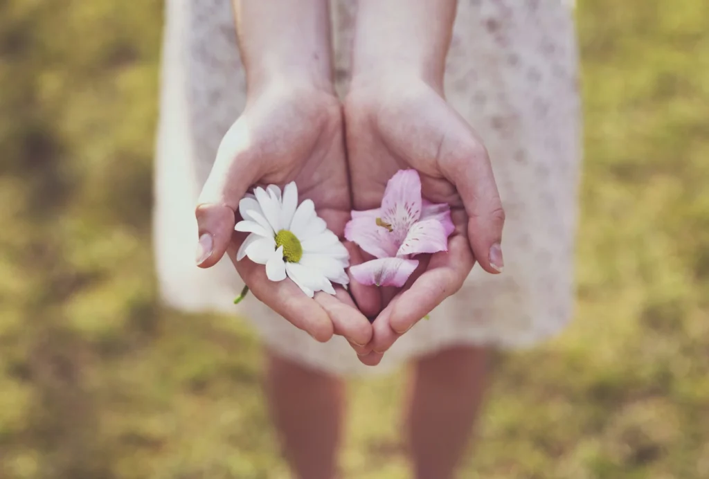 a person holding flowers in their hands