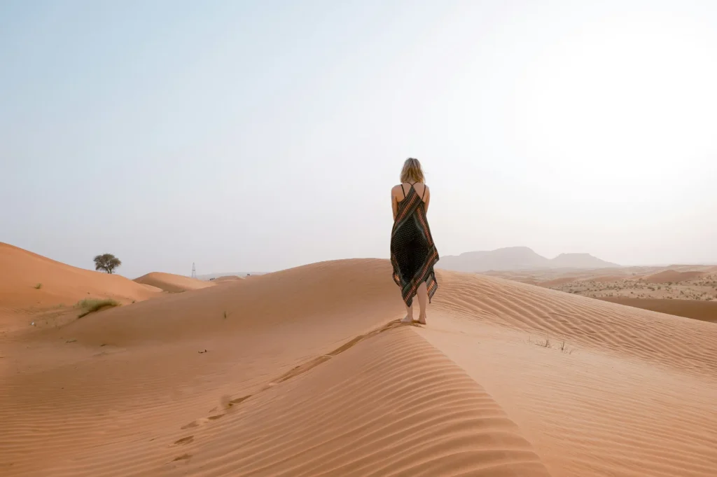 a woman standing on sand