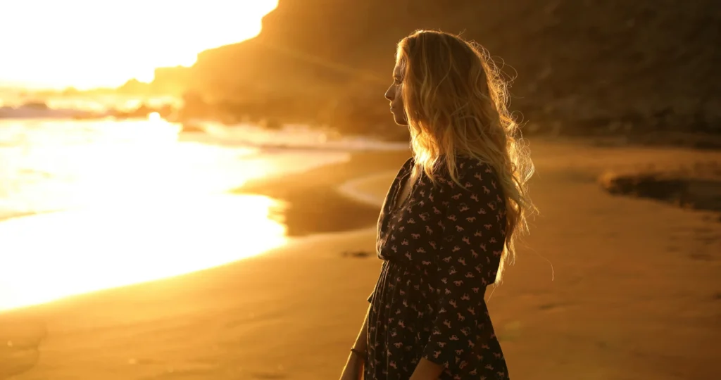a woman standing on a beach